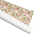 Gingerbread gift wrap, gingerbread people, trees, snowmen, candy canes and mittens on cream, 30 by 36 inch matte paper, shown partly rolled – Kate Spain design