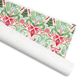 Wonderland gift wrap, ornaments, candy canes, trees and bells with red and green flourishes on cream, 30 by 36 inch matte paper, shown partly rolled – Kate Spain design